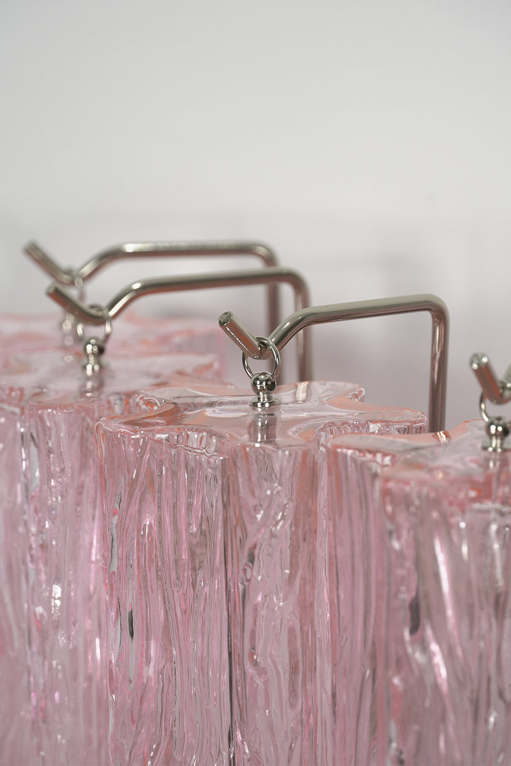 Cascading Prism Pink Glass Wall Light | Glass, Metal | Close-up focus on the silver-finished metal hardware and suspension system | Detail shot | Samu Lamp Cascading Prism