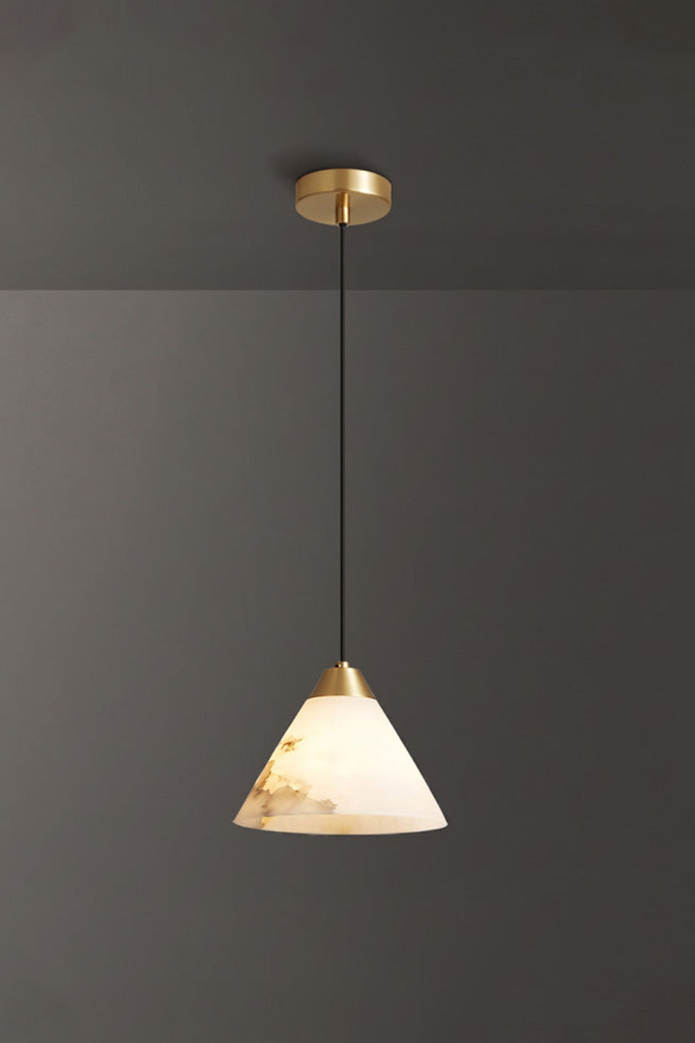 Caspian Conical Alabaster Pendant Light | Natural Alabaster and Brass | Single product view hanging fully lit with gold hardware options against a solid dark grey background | Samu Lamp