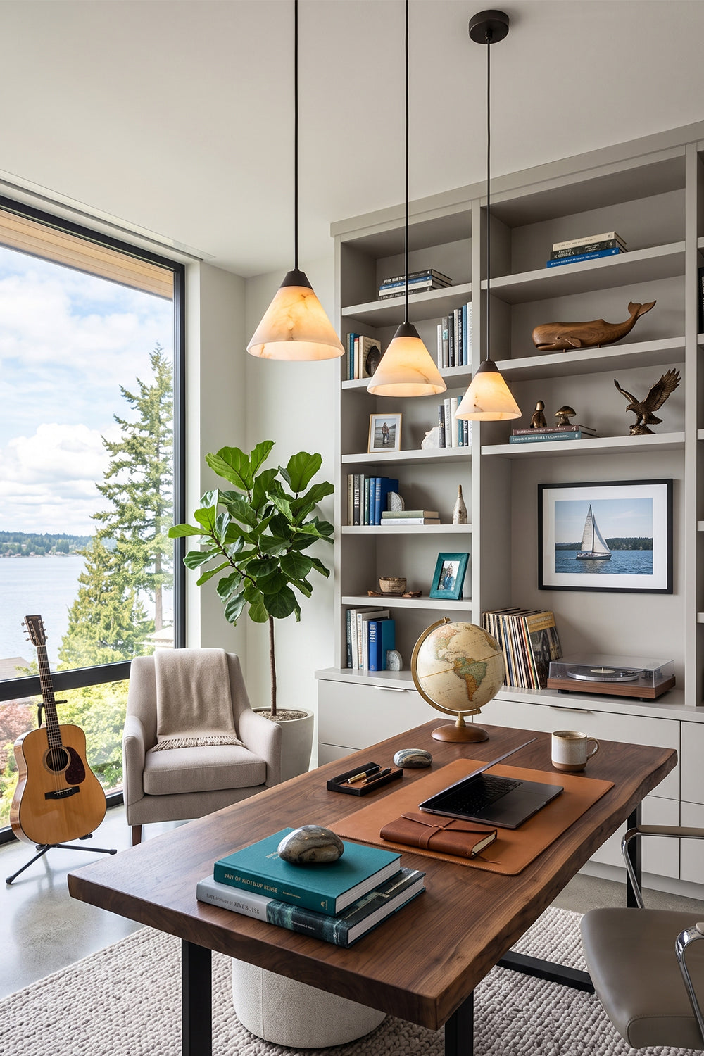 Caspian Conical Alabaster Pendant Light | Natural Alabaster and Brass | Hanging over a wooden study desk in a cozy home library room with a guitar on the wall | Samu Lamp