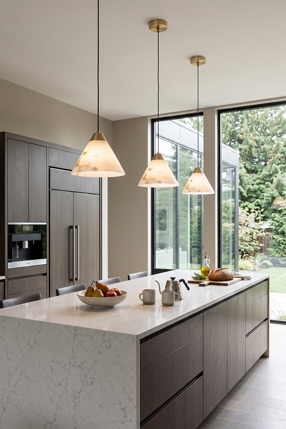 Caspian Conical Alabaster Pendant Light | Natural Alabaster and Brass | A row of three pendants illuminating a modern kitchen island with a clean marble counter | Samu Lamp
