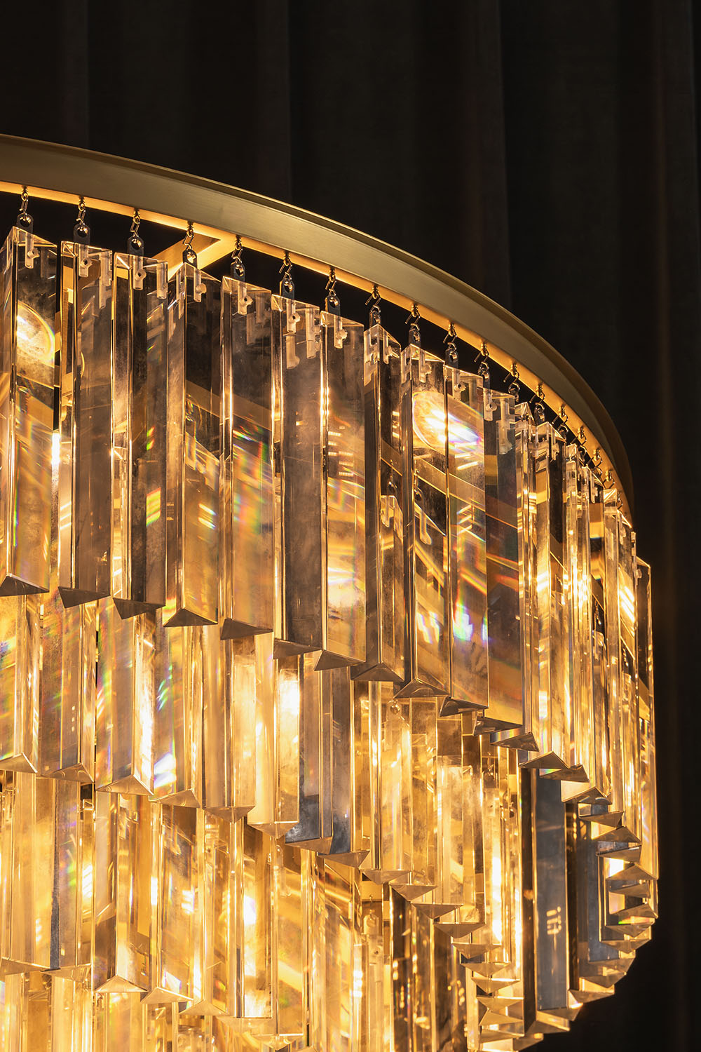 Cassian Tiered Prism Ring Chandelier | Clear Prism Glass and Brass | Close-up view of the brass ring and warm glowing glass prisms | Samu Lamp