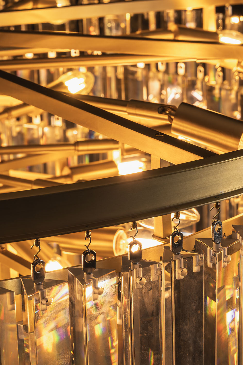 Cassian Tiered Prism Ring Chandelier | Clear Prism Glass and Brass | Detail shot looking through the tiers highlighting inner warm bulbs | Samu Lamp