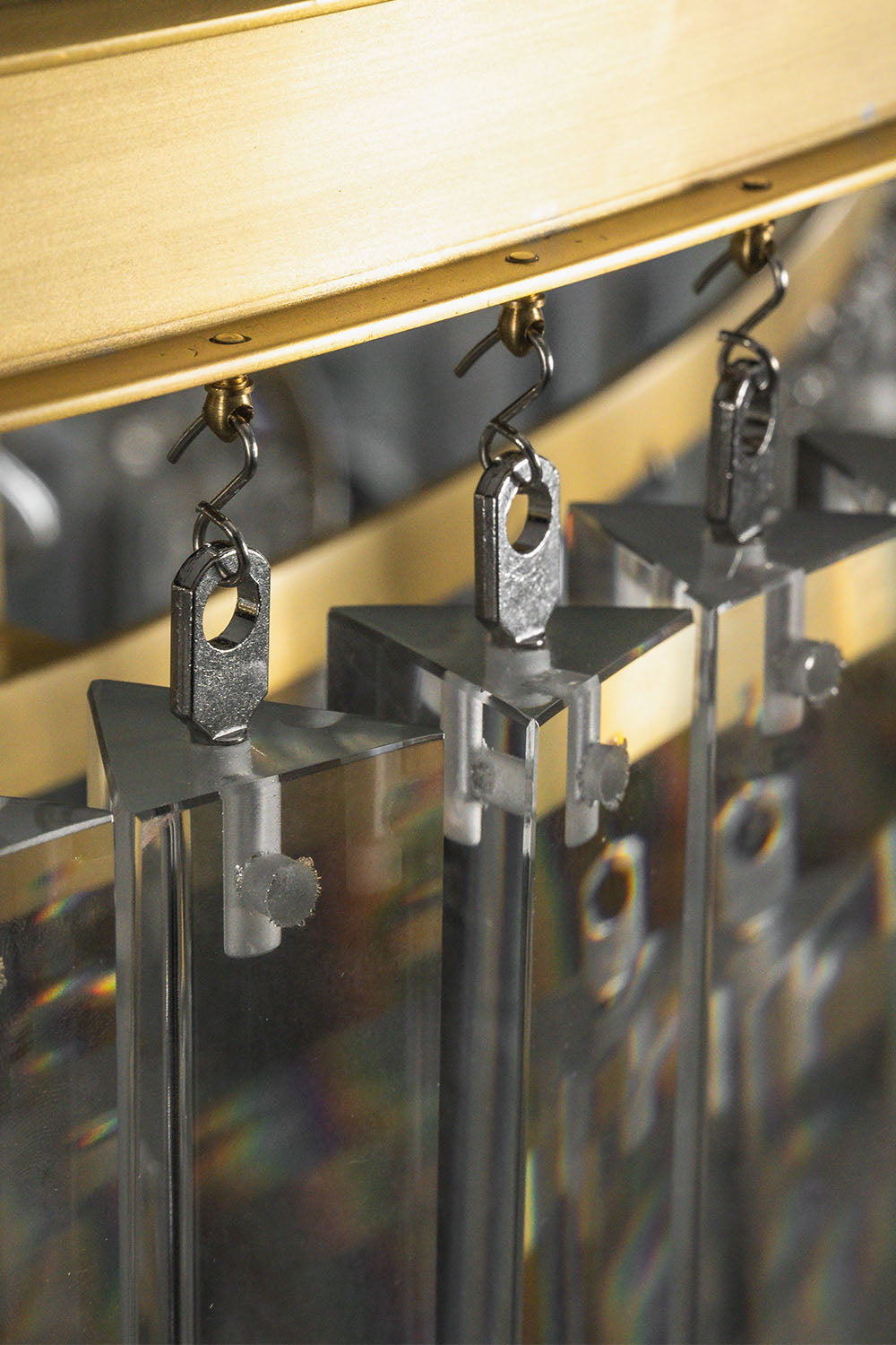 Cassian Tiered Prism Ring Chandelier | Clear Prism Glass and Brass | Close-up of the metal hooks attaching clear prisms to the frame | Samu Lamp