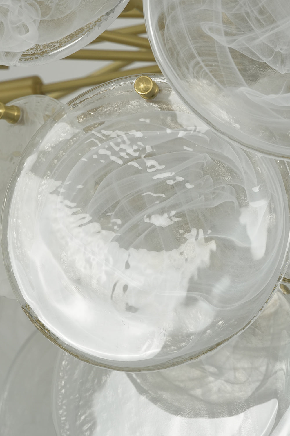 English: Celeste Glass Disc Chandelier | Glass, Metal | Detailed macro view of a single circular textured clear glass disc showing the mounting hole detail | Detail shot | Samu Lamp
