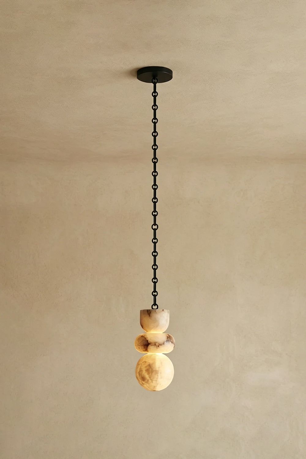 Single Alabaster Pendant | Alabaster, Metal | Straight vertical hanging against neutral wall | Samu Lamp