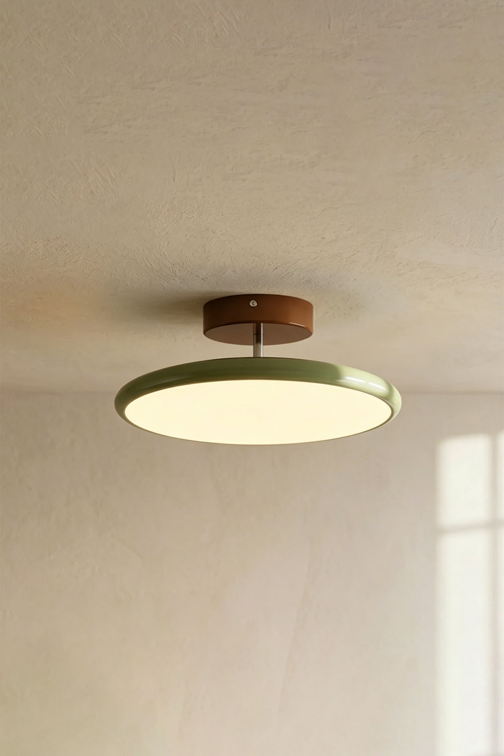 Celestial Disc Lacquered Ceiling Light | Acrylic, Metal | Angled side-profile view of the unlit green-trimmed light on a grey wall, showing depth | Detail shot | Samu LampCelestial Disc