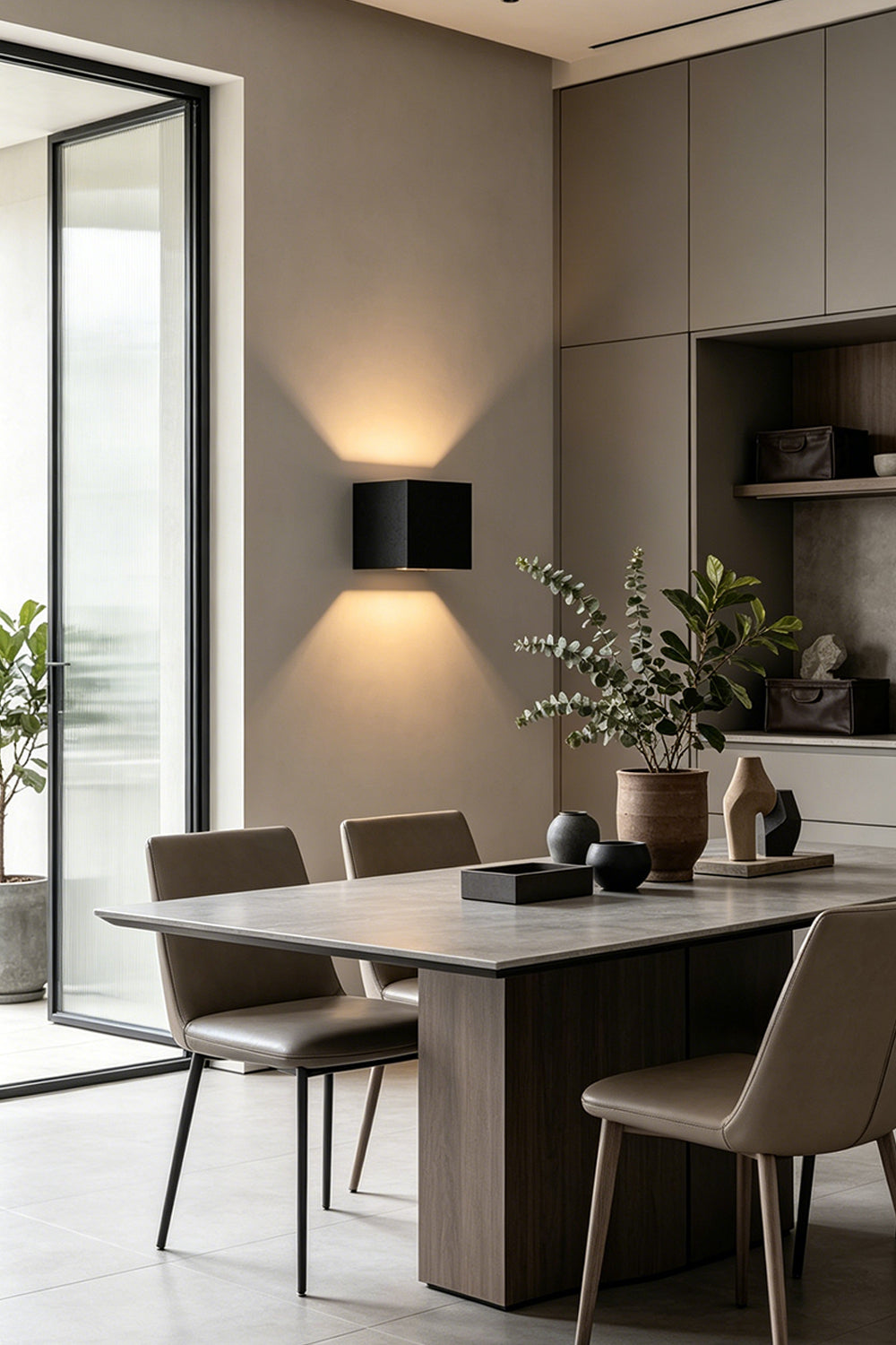 Celestial Tectonic Black Travertine Wall Lamp | Black Travertine | Dining room installation with warm up-and-down glow | Samu Lamp