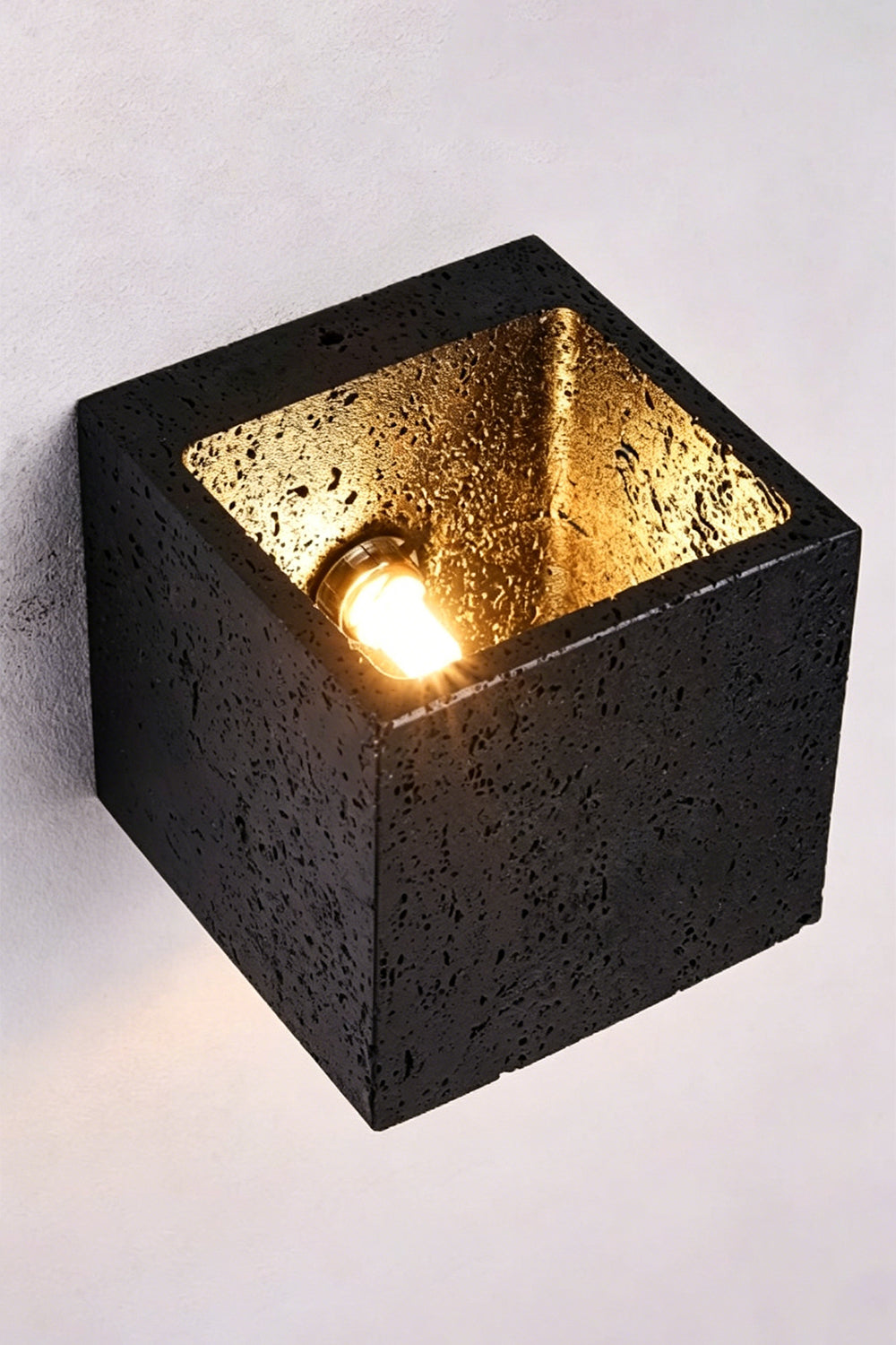 Celestial Tectonic Internal View | Black Travertine | Top-down view of internal bulb and textured gold lining | Samu Lamp