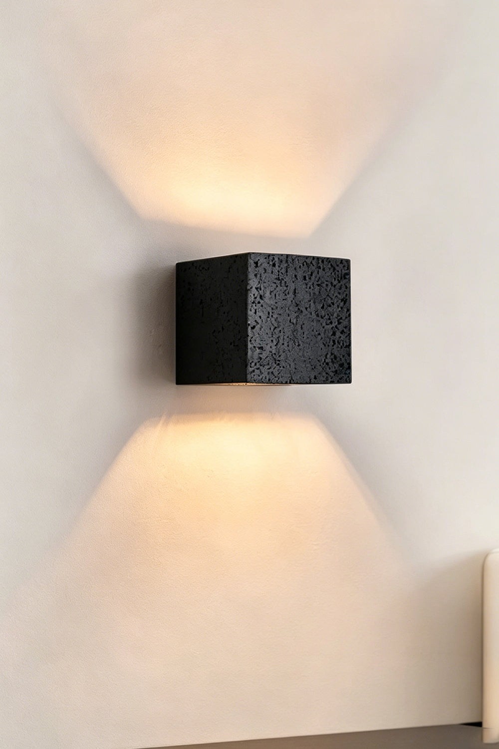 Celestial Tectonic Black Travertine Wall Lamp | Black Travertine | Frontal view emphasizing dramatic up-down light distribution | Samu Lamp
