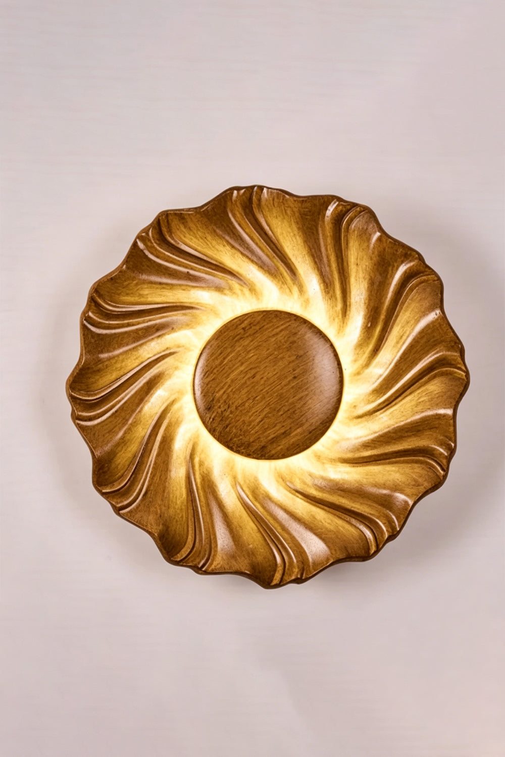 Centripetal Solstice Metal Wall Lamp | Metal, Resin | Wood grain textured lamp on a plain background, providing warm light | Isolated lit variant shot | Samu Lamp