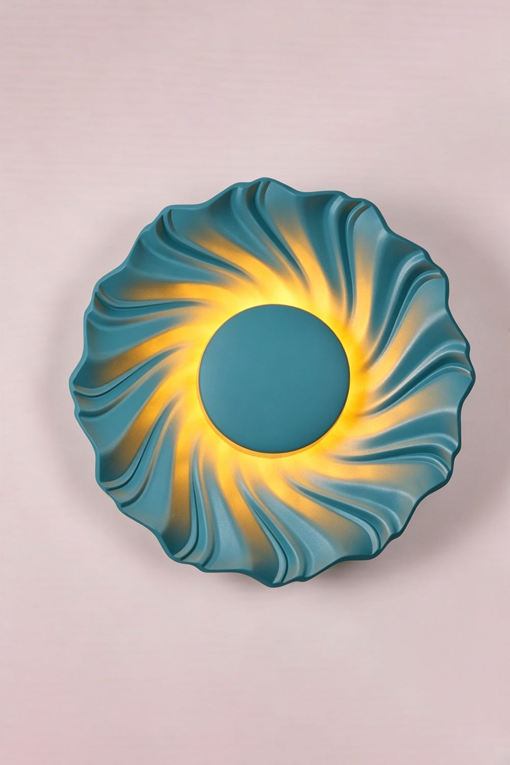 Centripetal Solstice Metal Wall Lamp | Metal, Resin | Blue textured lamp on a plain background, providing warm light | Isolated lit variant shot | Samu Lamp