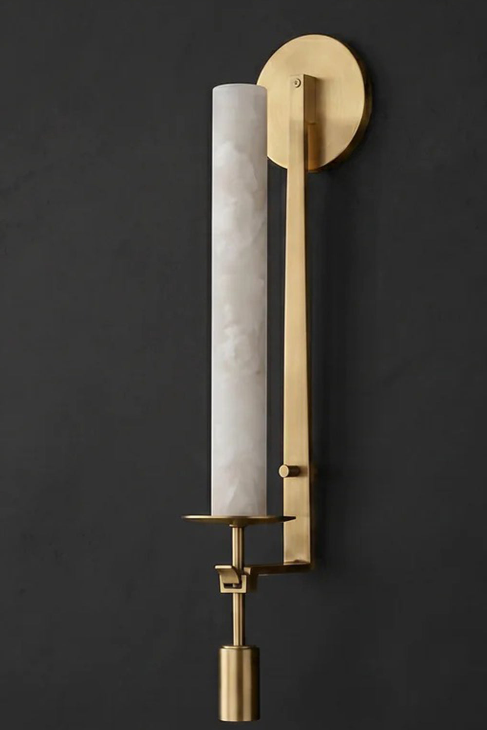 Chantal Twin Alabaster Wall Sconce | Alabaster, Brass | Staged close-up profile view of the single-light brass stone sconce showcasing the cylindrical white alabaster veins against a dark background | Detail shot | Samu Lamp