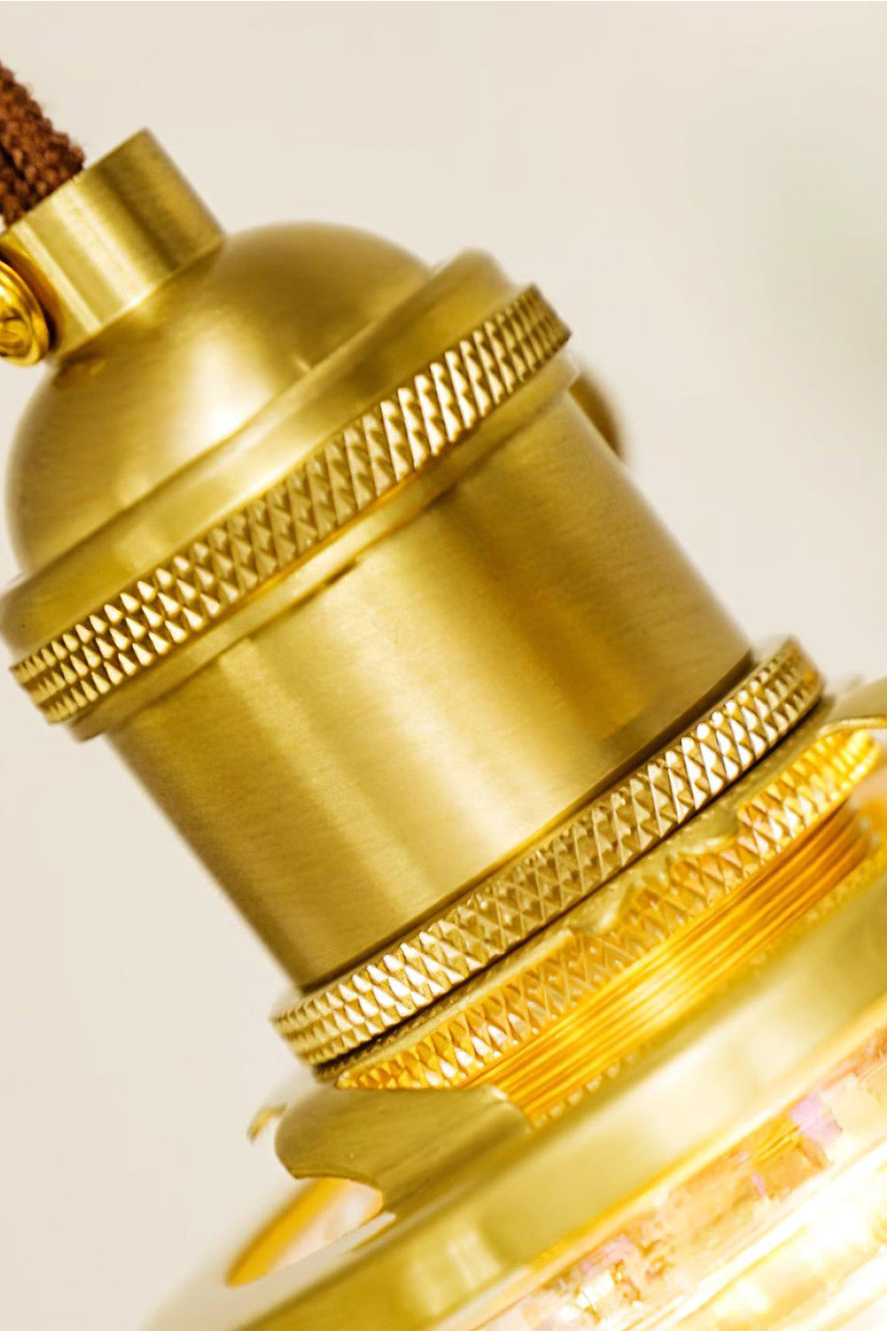 Chroma Drip Rainbow Resin Pendant Lamp | Resin, Metal | Macro focus on the finely threaded knurled gold brass metal fixture socket sitting atop the shade | Detail shot | Samu Lamp