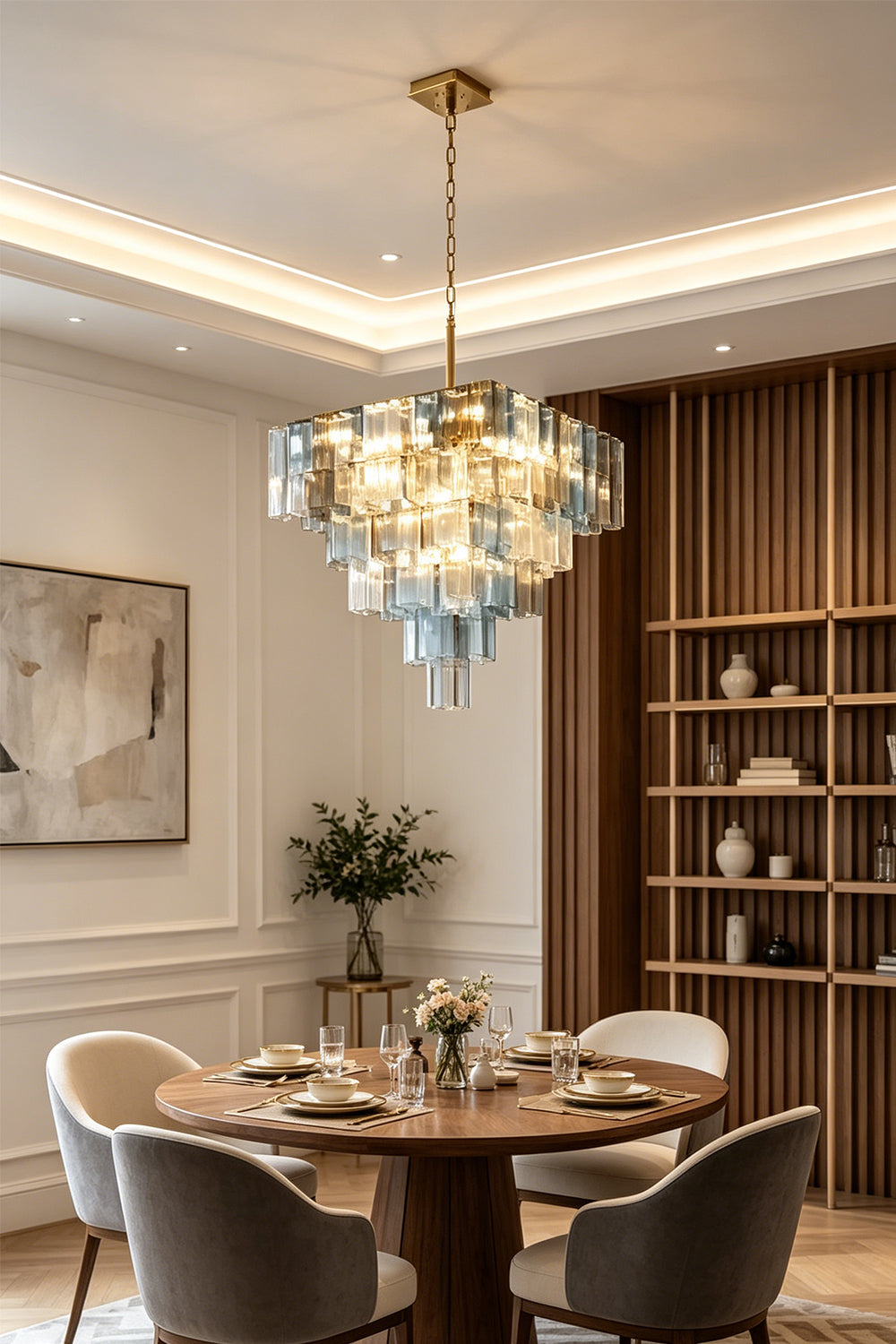 Clarissa Tiered Square Glass Chandelier | Dining Room Chandelier | Hanging elegantly as a centerpiece over a round wooden dining table and contemporary chairs in a luxury dining space | Samu Lamp