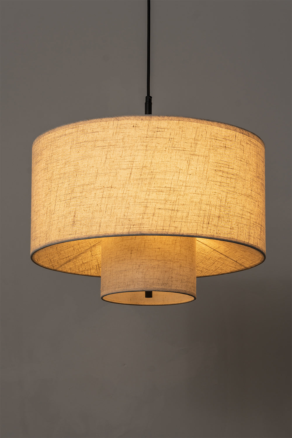 Concentric Veil Fabric Pendant Light | Fabric | Side-view lit product shot against a neutral grey background | Samu Lamp