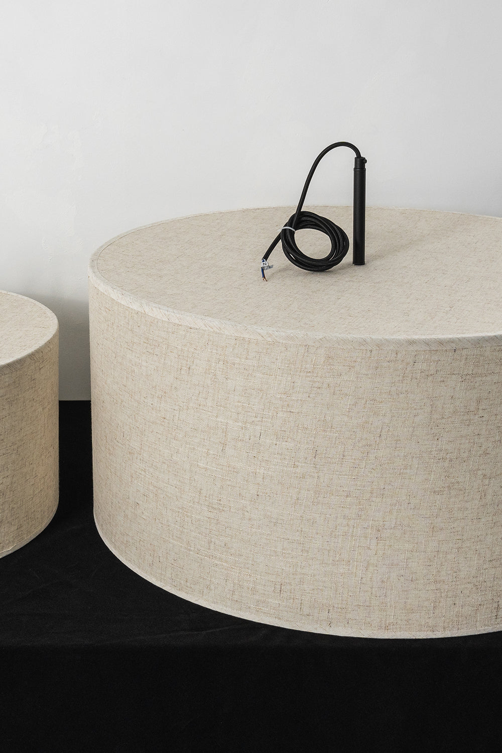 Concentric Veil Detail | Fabric, Metal | Top-down view of black cord and shade connection on a white surface | Samu Lamp