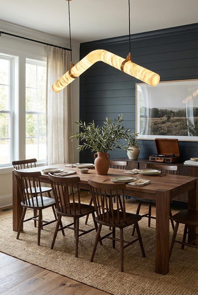 Linear undulating alabaster chandelier | Alabaster, Brass | Mounted in a bright wooden dining area with natural light | Samu Lamp
