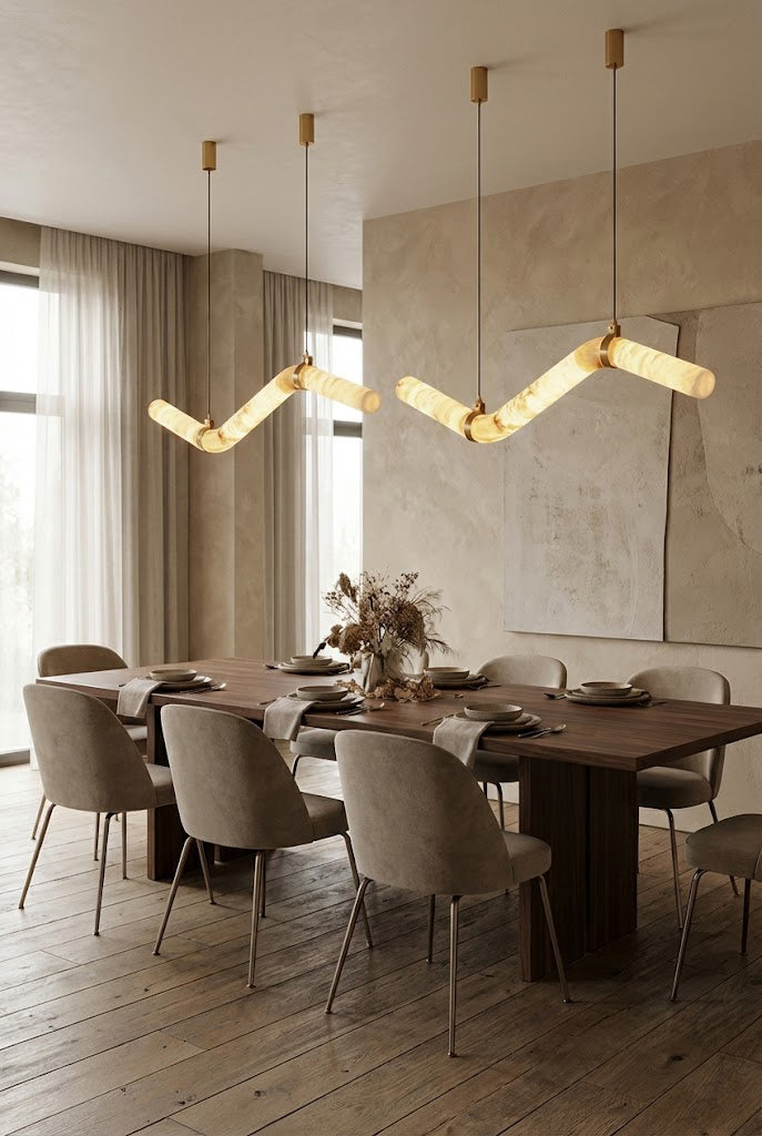 Pair of undulating alabaster tube chandeliers | Alabaster, Brass | Symmetrical installation in a neutral-toned dining room | Samu Lamp