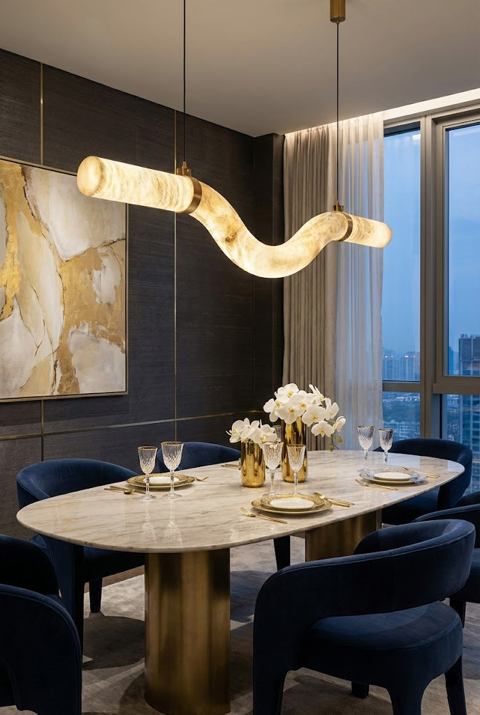 Undulating alabaster tube chandelier over marble table | Alabaster, Brass | Elegant dining room with blue velvet chairs | Samu Lamp