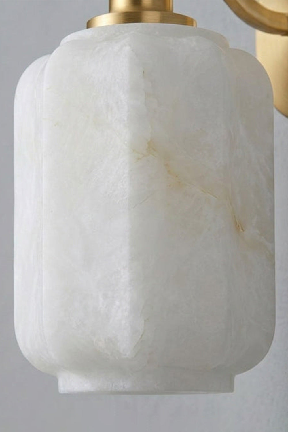 Cordelia Scalloped Alabaster Wall Sconce | Natural Alabaster and Brushed Brass | Close-up texture shot highlighting the vertical faceted edges and natural veins of the stone shade | Samu Lamp