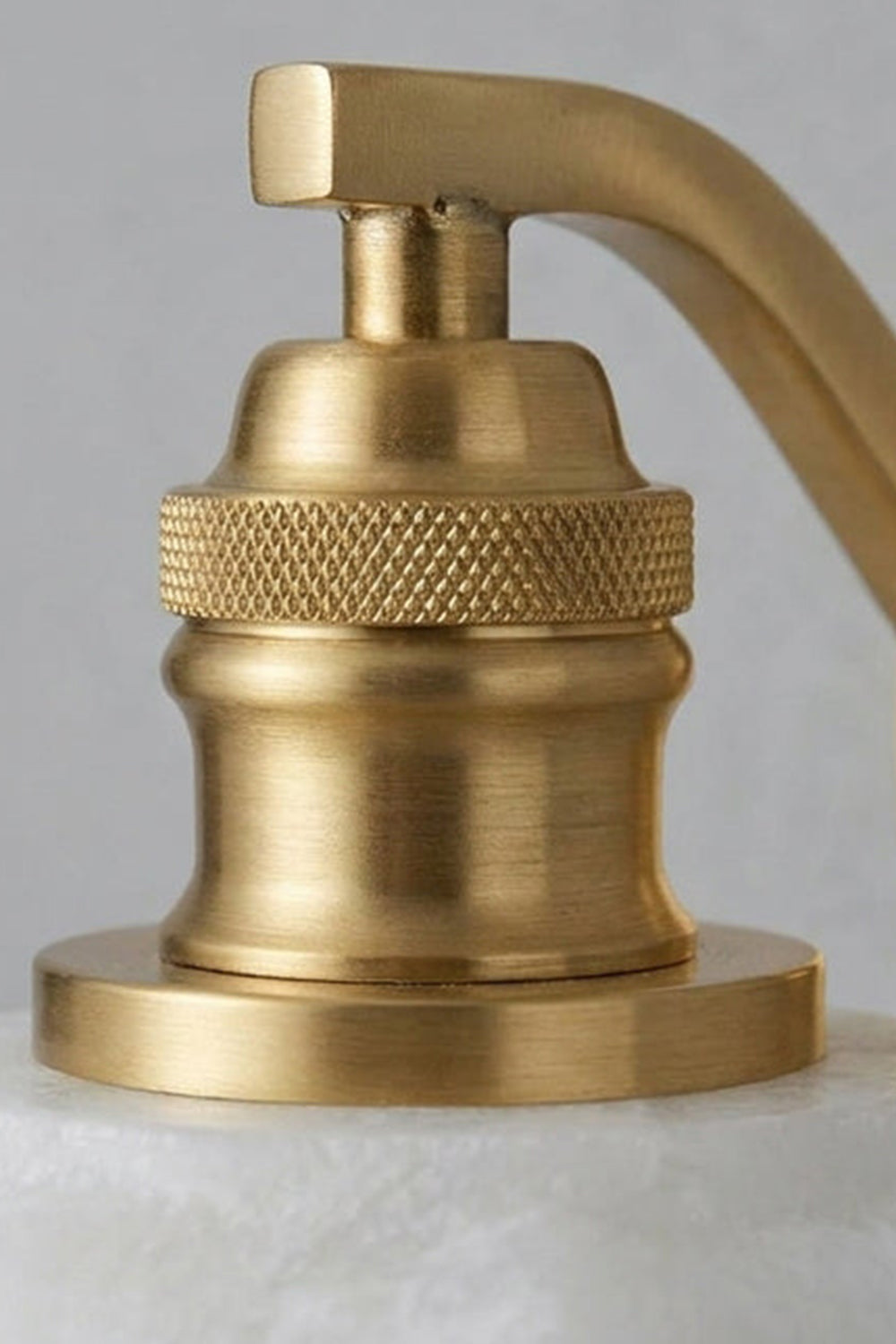 Cordelia Scalloped Alabaster Wall Sconce | Natural Alabaster and Brushed Brass | Extreme close-up preview of the intricate knurled textured brass socket and hardware craftsmanship | Samu Lamp