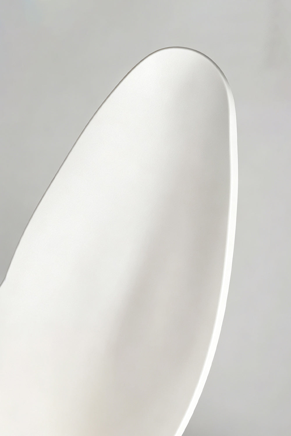  Corin Low-Profile Ceiling Fan Light  Close-up of the sleek design of a modern white ceiling fan blade with a smooth finish.