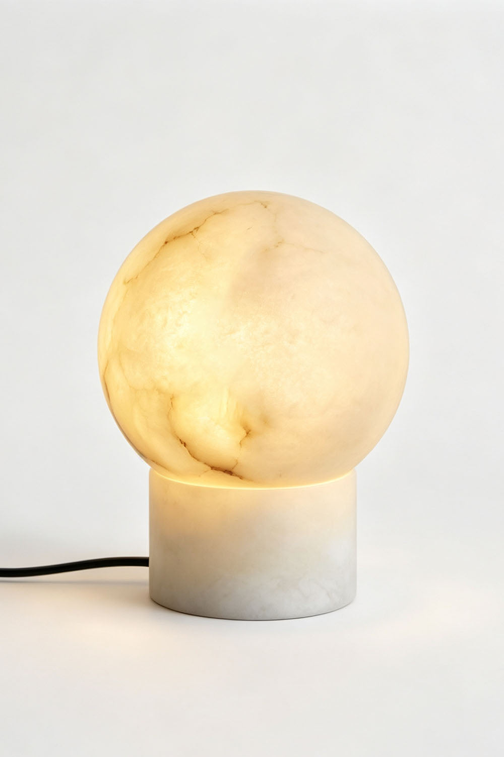 Cosima Alabaster Globe Table Lamp | Natural Alabaster | Full illuminated view displayed against a plain studio background | Samu Lamp