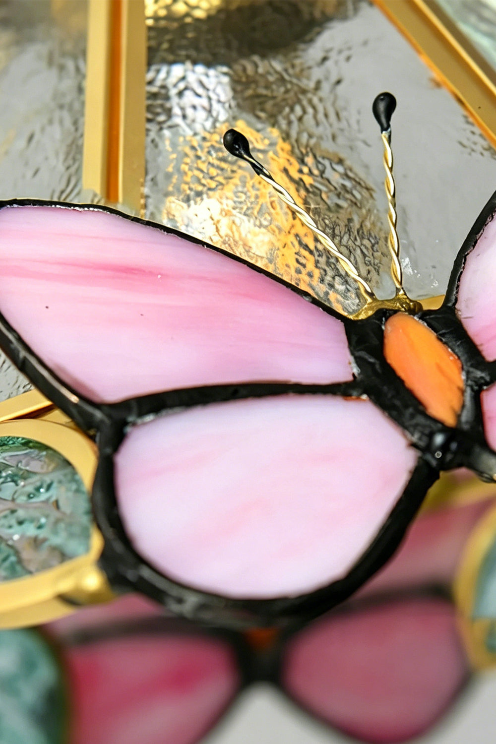 Cynthia Butterfly Articulated Wall Lamp | Stained Glass, Metal, Wood | Macro close-up focus on a pink stained glass butterfly wing section with clean solder lines and delicate wire antennas | Detail shot | Samu Lamp