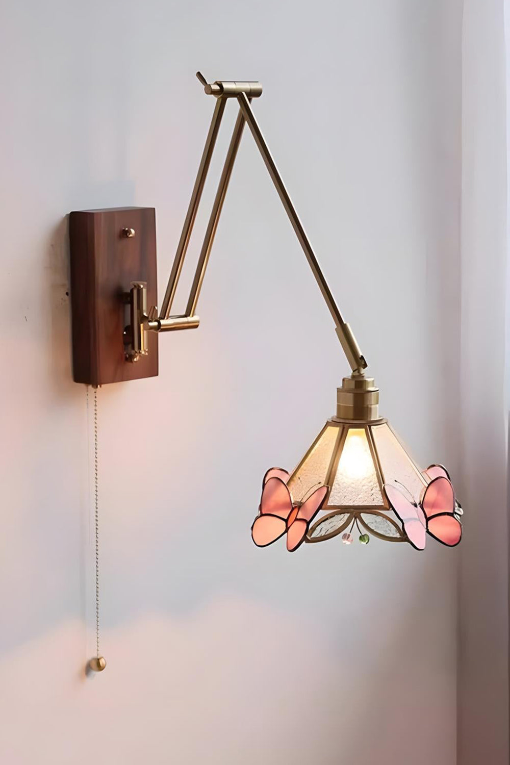 Cynthia Butterfly Articulated Wall Lamp | Stained Glass, Metal, Wood | Profile side view of the unlit articulated lamp mounted on a plain white wall, showing its extended arm reach | Samu Lamp
