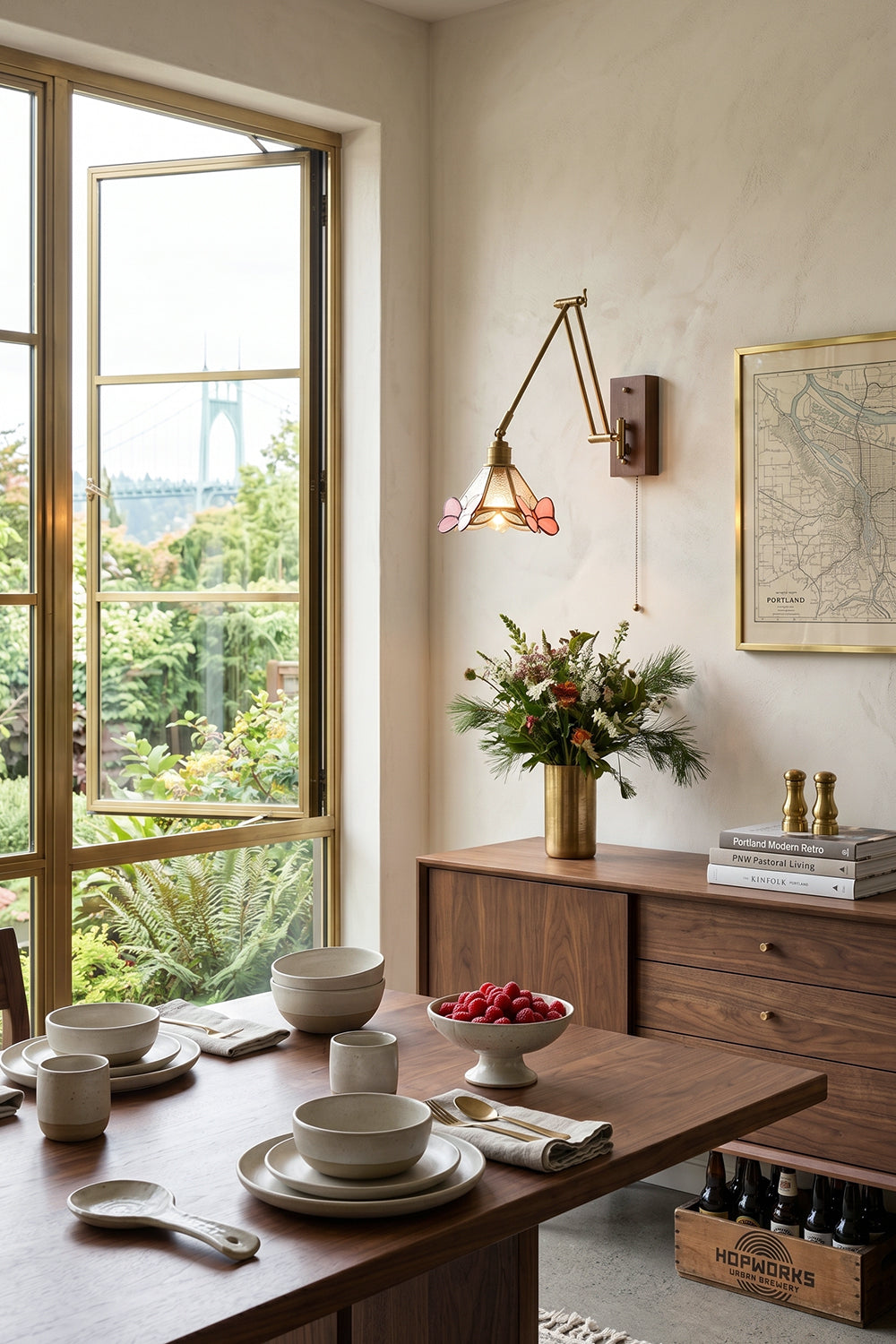 Cynthia Butterfly Articulated Wall Lamp | Stained Glass, Metal, Wood | Wall-mounted in a sunlit dining area next to a wooden dining table and large open glass doors overlooking a lush garden | Samu Lamp