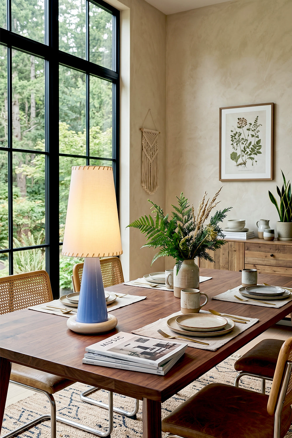 Dolce Ribbon Ceramic Table Lamp | Ceramic, Fabric | Illuminating a rustic modern dining space, casting a soft ambient light on a long wood table set near large grid windows | Samu Lamp