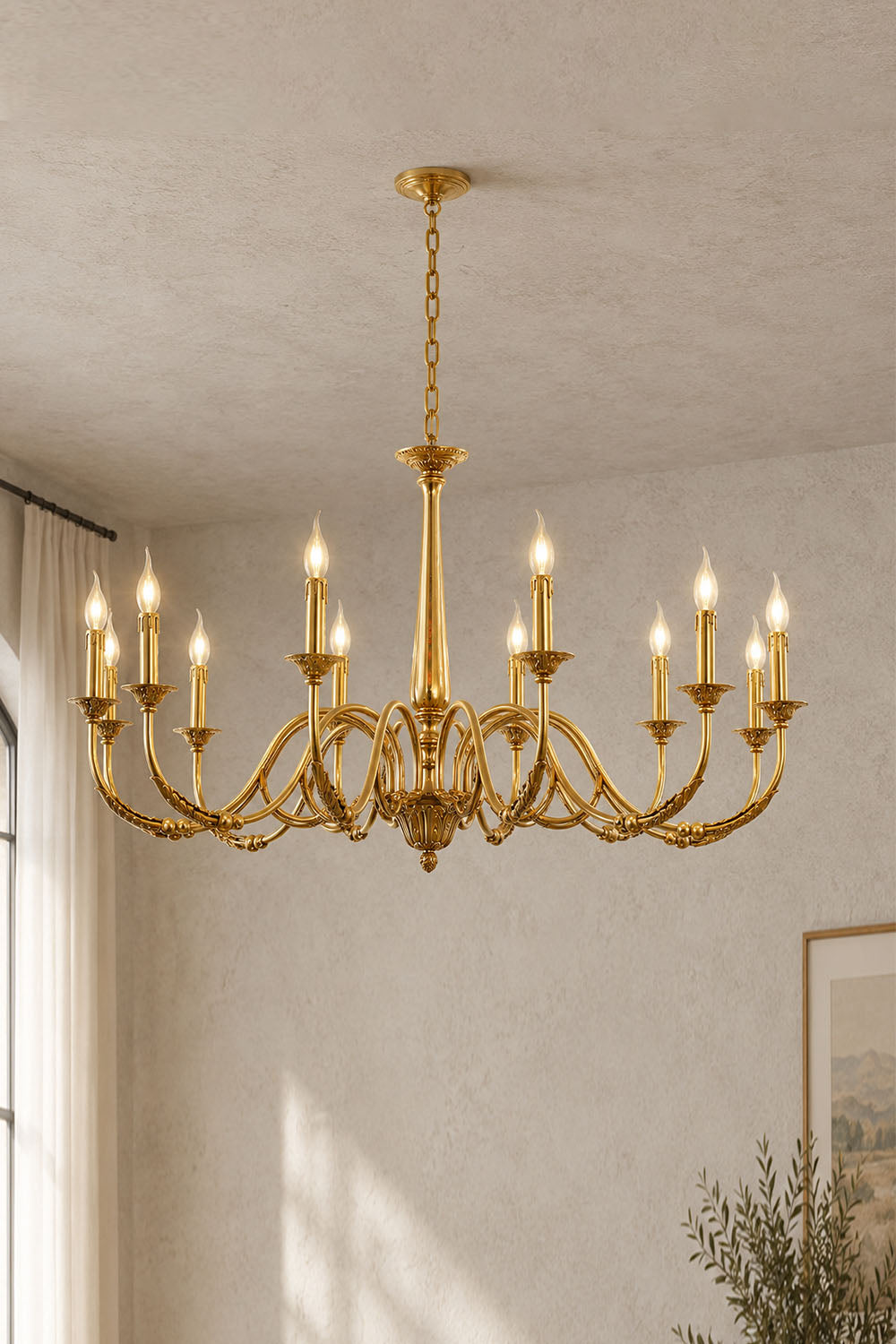 Dorvanne Brass Scroll Arm Candle Chandelier | Solid Brass | Large variant glowing softly in a plain room | Samu Lamp