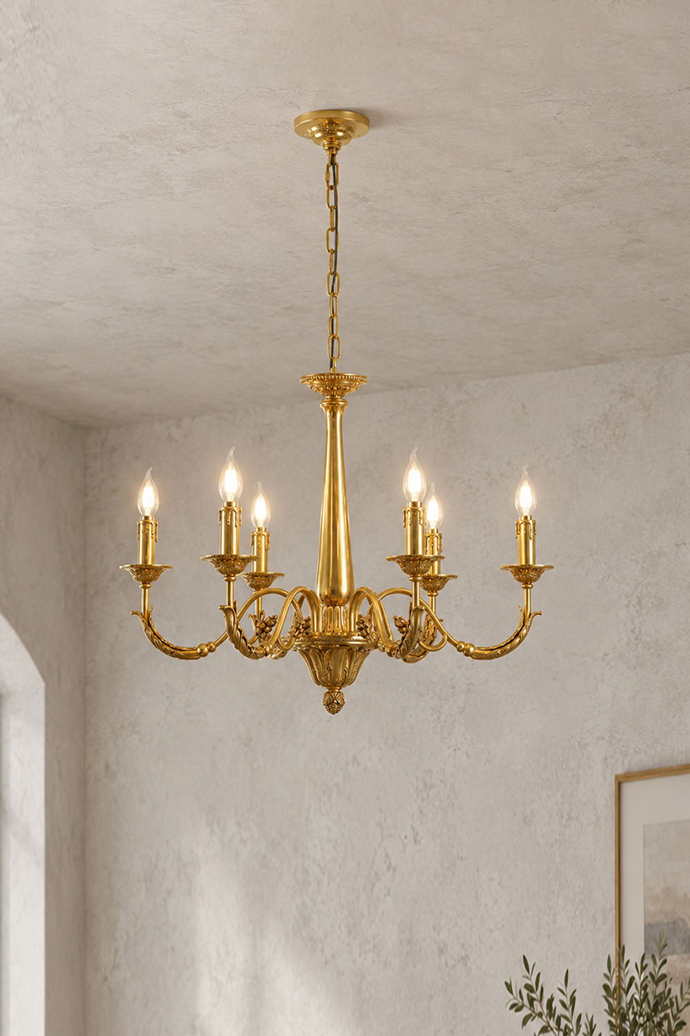Dorvanne Brass Scroll Arm Candle Chandelier | Solid Brass | 8-light variant illuminated in a plain room | Samu Lamp