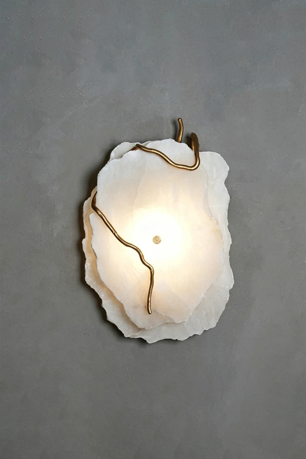 Double layer Arboreal Alabaster Wall Lamp with unique raw edges and gold accents illuminating a wall.