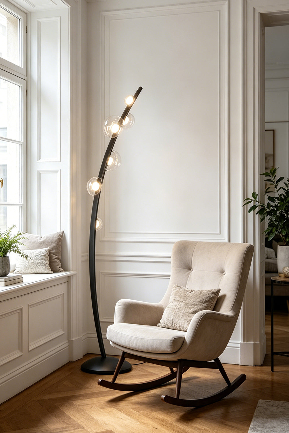 Drosia Dewdrop Floor Lamp | Glass, Metal | Placed next to a tufted beige fabric rocking armchair near a window, providing perfect accent lighting in a serene living room corner | Samu Lamp