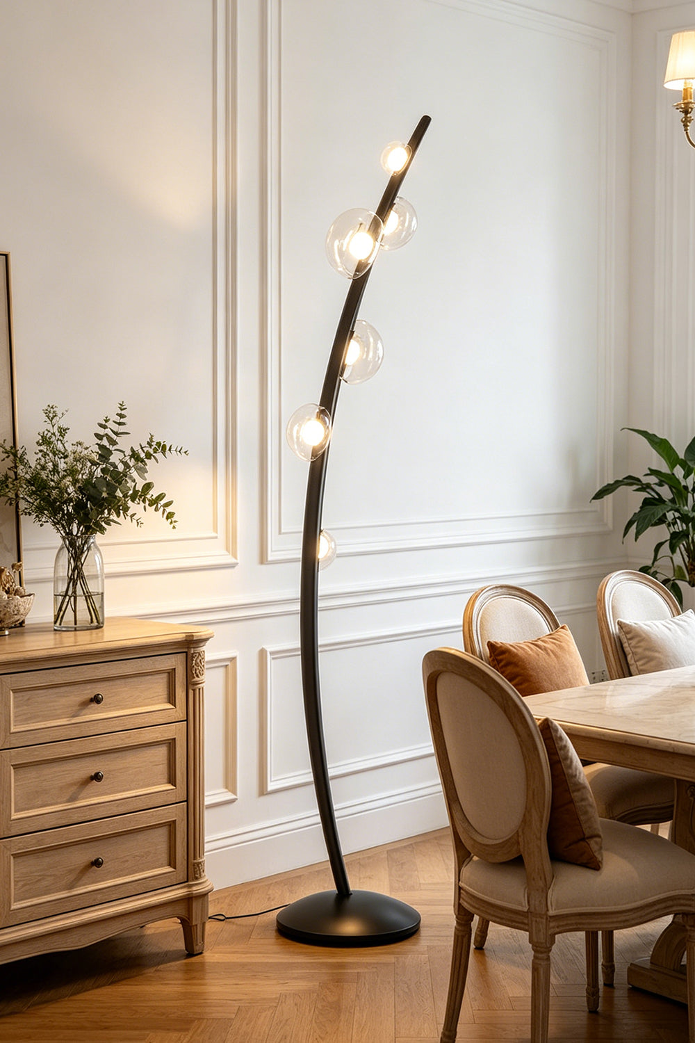Drosia Dewdrop Floor Lamp | Glass, Metal | Illuminating a classical dining room nook, casting a warm ambient glow next to a wooden console cabinet and dining chair | Samu Lamp
