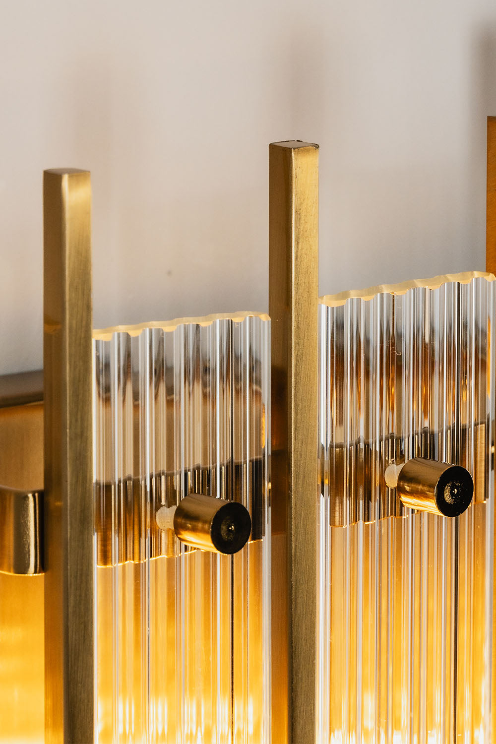 Drystan Ribbed Glass Brass Wall Lamp showcasing elegant ribbed glass and brass finish.