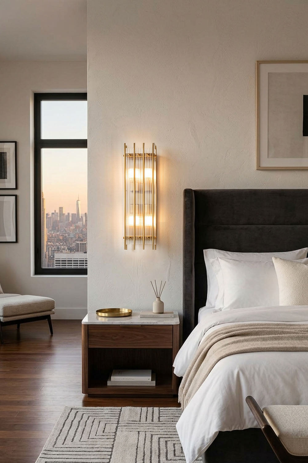 Drystan Ribbed Glass Brass Wall Lamp illuminating a modern bedroom with stylish decor.