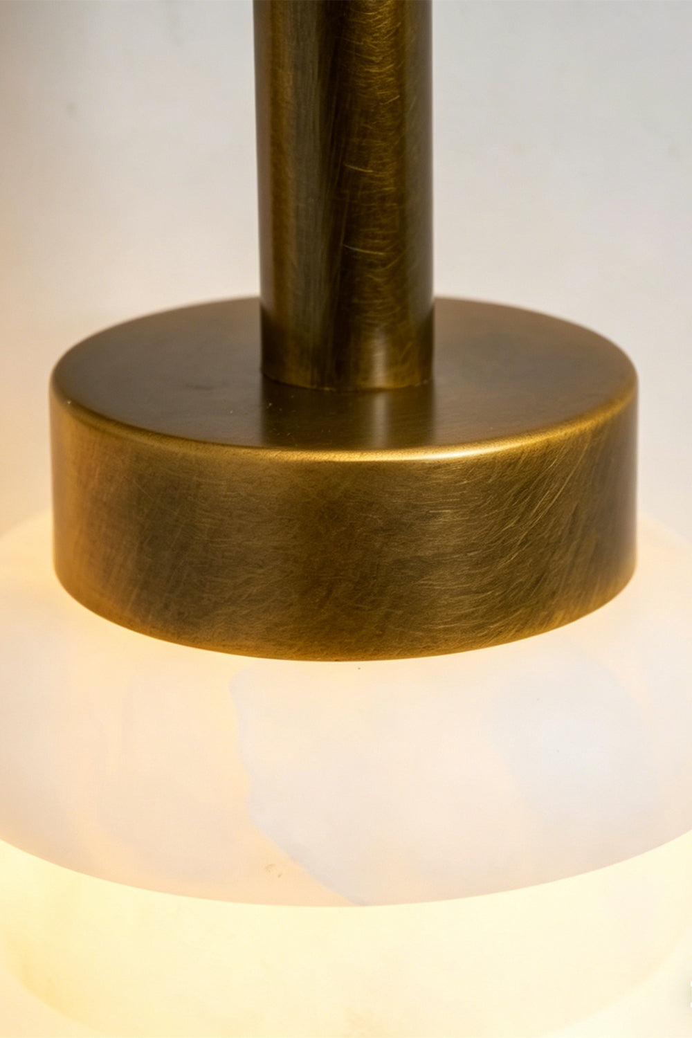 Dual Strata Alabaster Wall Lamp | Metal, Alabaster | Perspective view of lit lamp against a light grey background | Samu Lamp