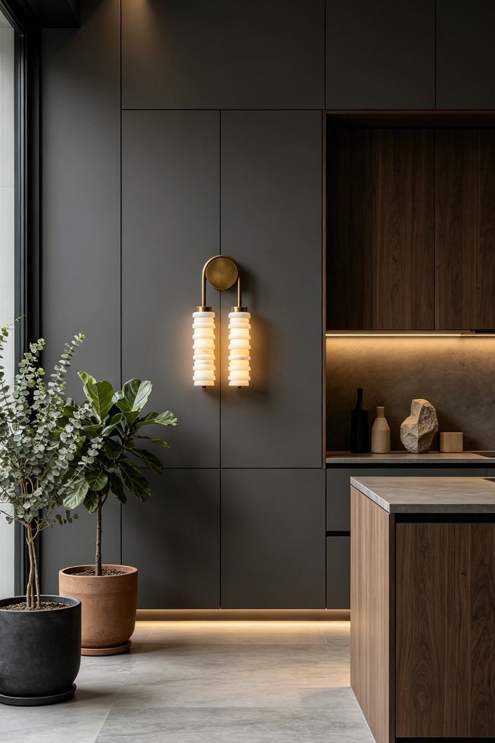 Dual Strata Alabaster Wall Lamp | Metal, Alabaster | Lit lamp providing accent light in a modern kitchen with textured wood cabinetry and island | Samu Lamp
