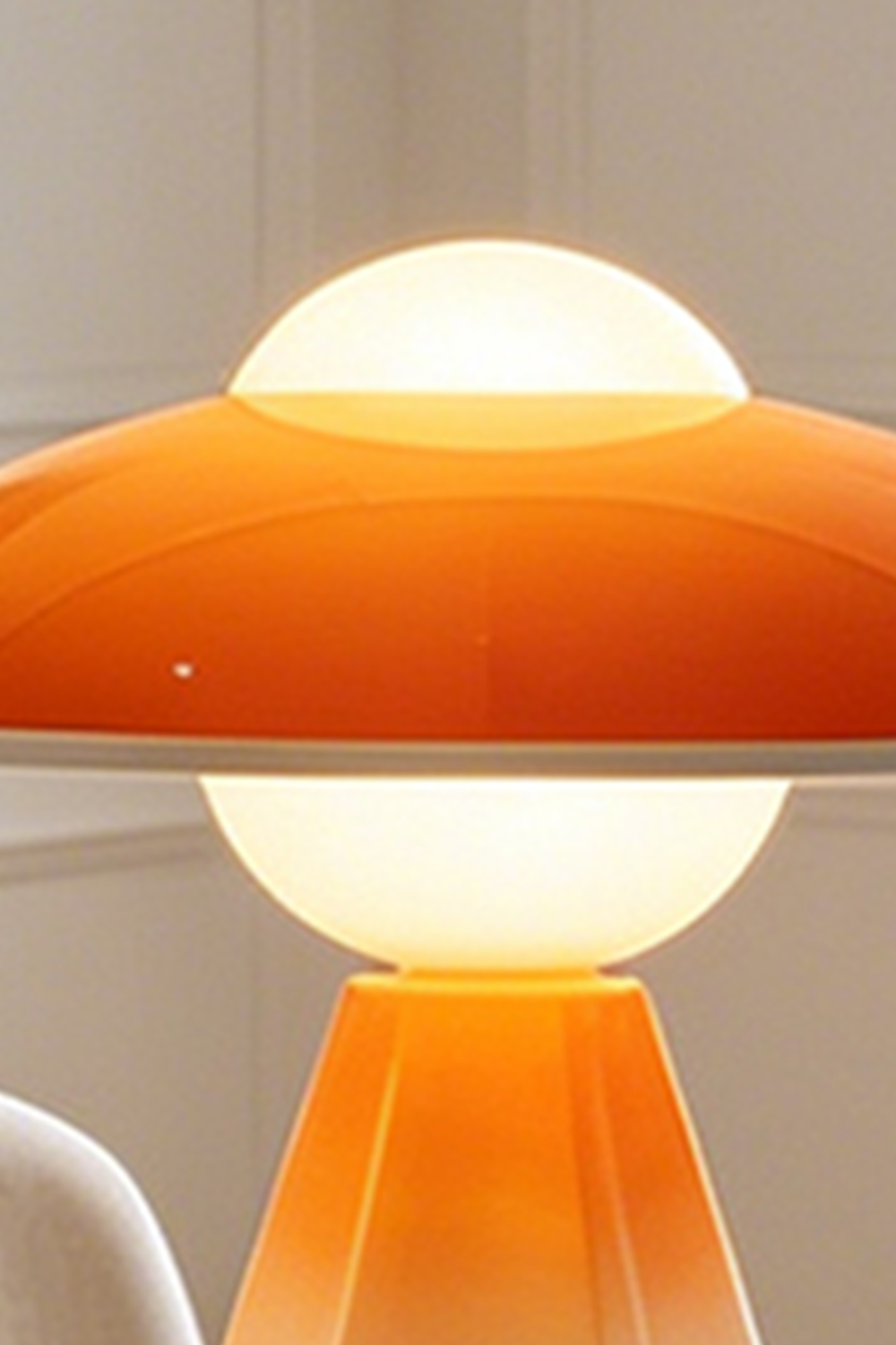 Duskora Retro Mushroom Table Lamp | Ceramic, Glass | Detailed illuminated view highlighting the vibrant translucent orange glossy mushroom dome cap and creamy white diffuser top | Detail shot | Samu Lamp