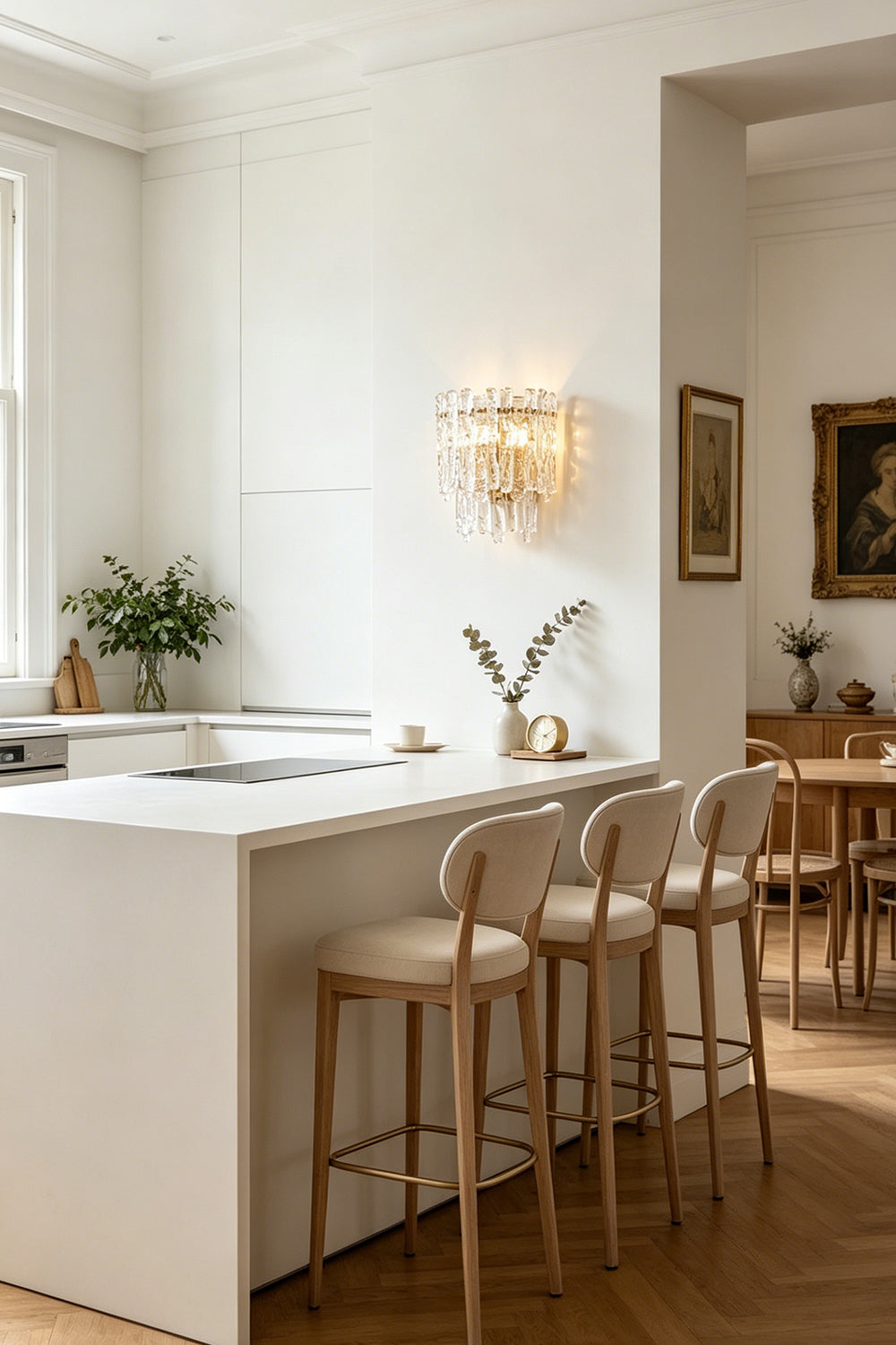 Elara Textured Cast Glass Wall Lamp | Textured Cast Glass, Polished Brass | View across a formal dining room, showing the lamp on a distant wall, balancing the composition with classical architecture and a fireplace | Samu Lamp