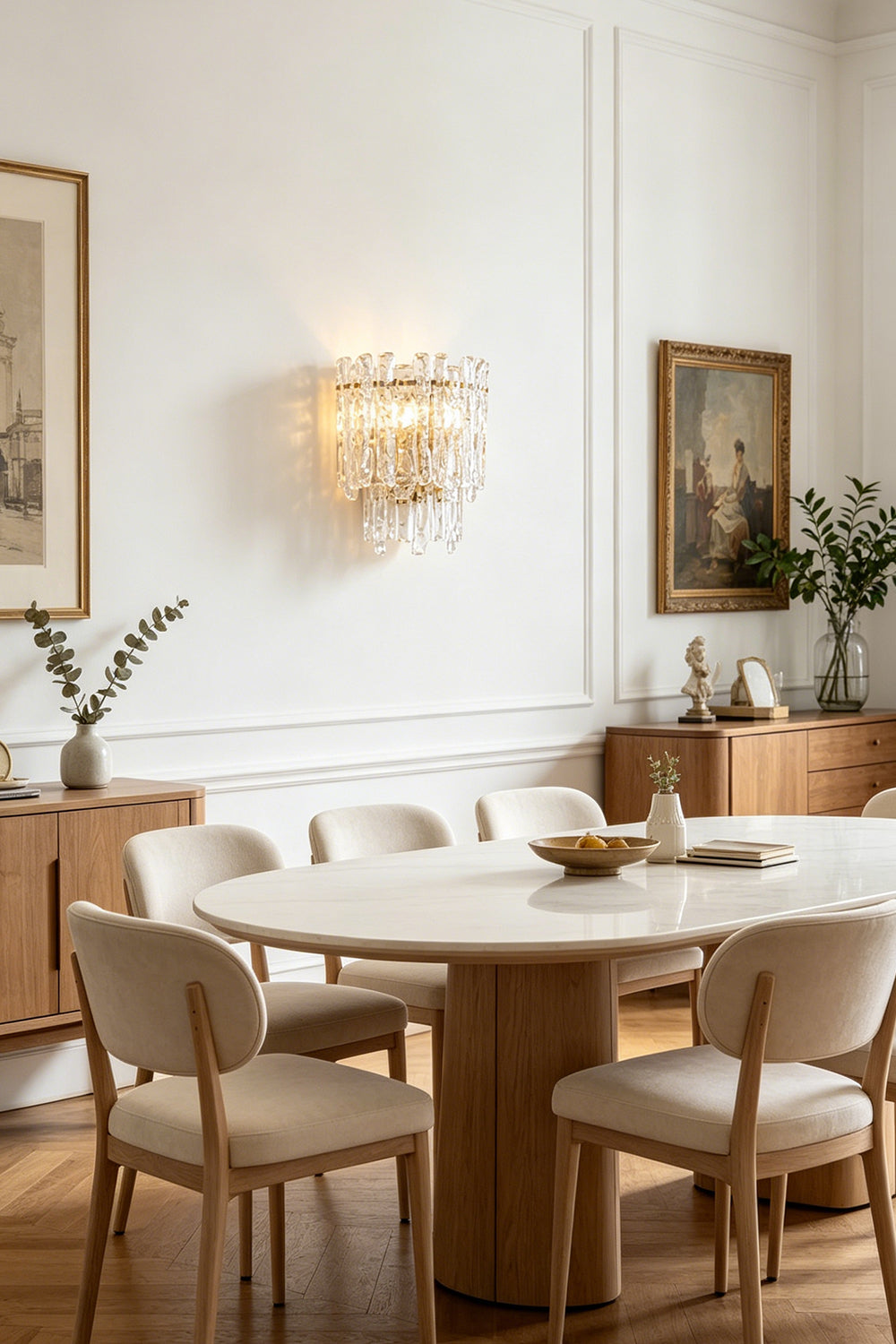 Elara Textured Cast Glass Wall Lamp | Textured Cast Glass, Polished Brass | Set above an oval wooden dining table and matching chairs, creating a sophisticated dining ambiance near a large window and sideboard | Samu Lamp