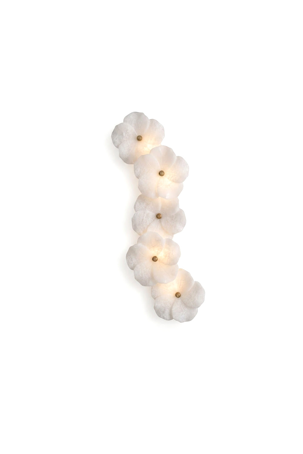 Elowen Alabaster Blossom Wall Light | Alabaster, Brass | Isolated lit view of a vertical linear wall sconce composed of overlapping hand-carved natural white alabaster flower blossoms with central brass accents | White background | Samu Lamp
