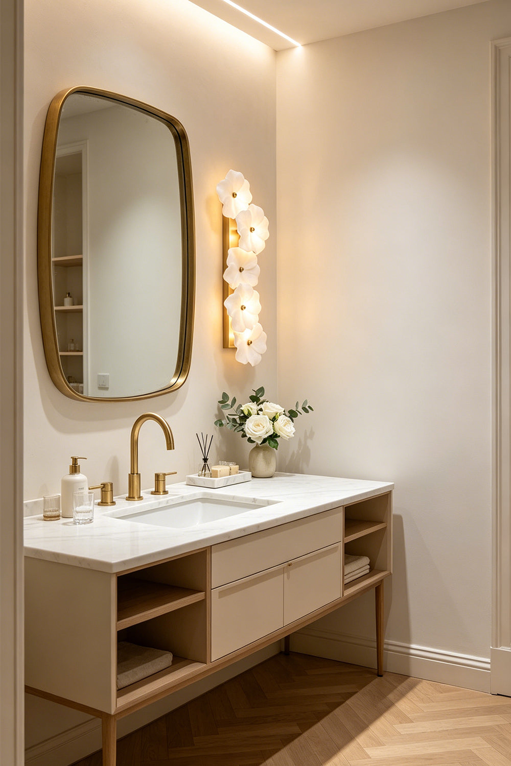 Elowen Alabaster Blossom Wall Light | Bedroom Sconce | Mounted vertically as a luxury bedside accent light casting a warm golden glow next to a cream platform bed and nightstand | Samu Lamp