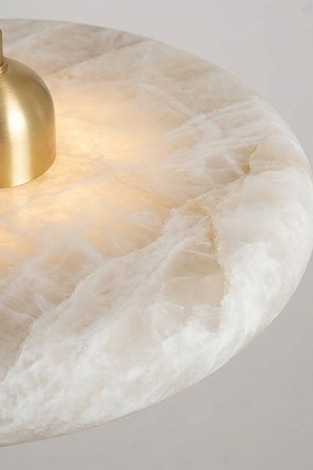 Elowen Alabaster Disc Pendant Light | Natural Alabaster and Brass | Detailed macro texture shot focusing on the natural organic veining of the circular stone shade | Samu Lamp