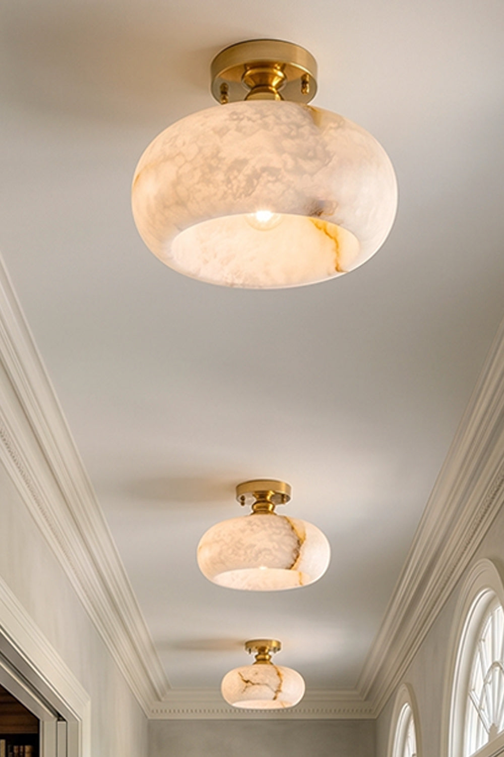 Elowen Alabaster Semi-Flush Ceiling Light illuminating a hallway, showcasing its warm glow and natural alabaster design.