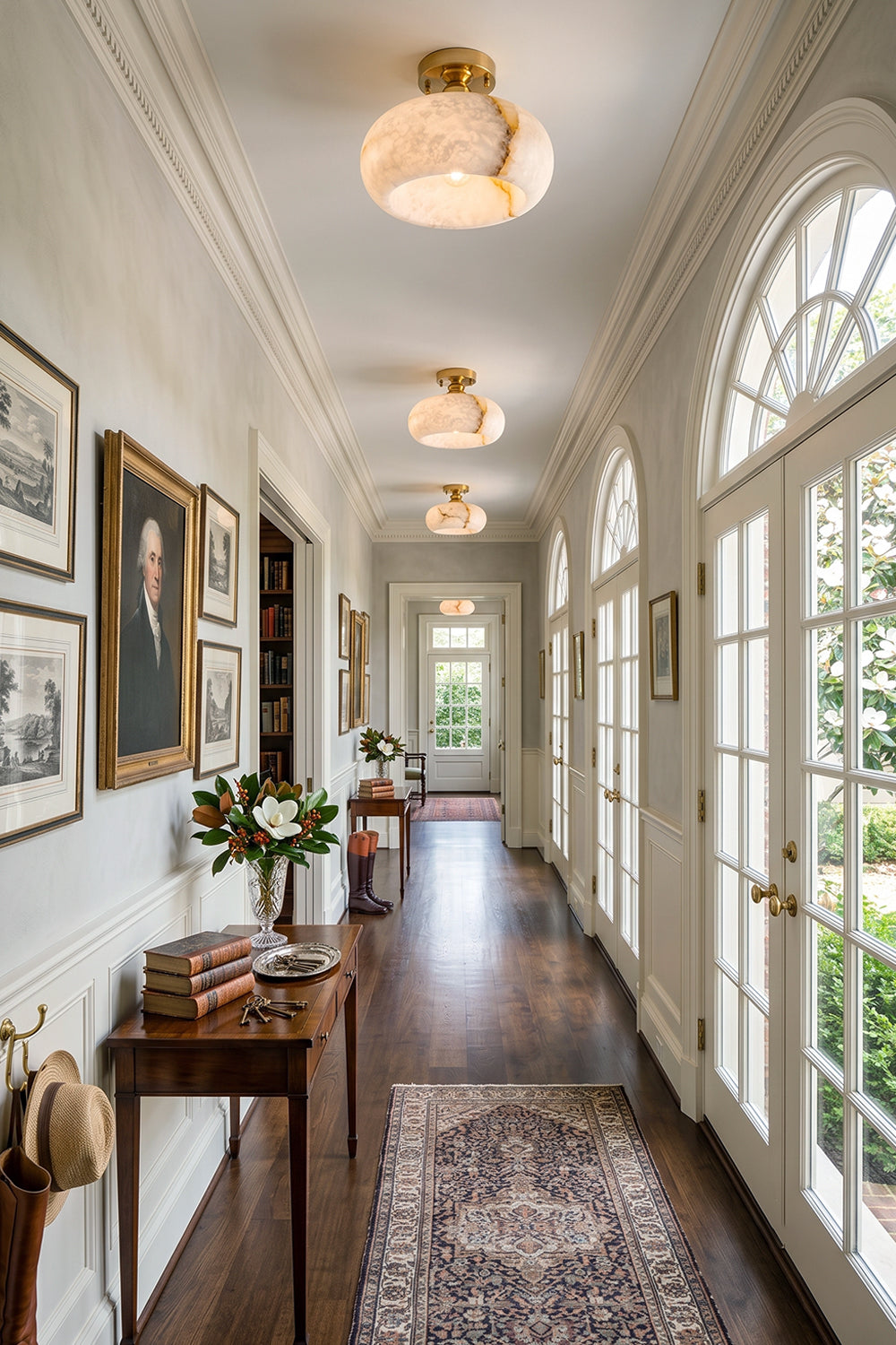 Elowen Alabaster Semi-Flush Ceiling Light illuminating a stylish hallway with elegant decor and art.