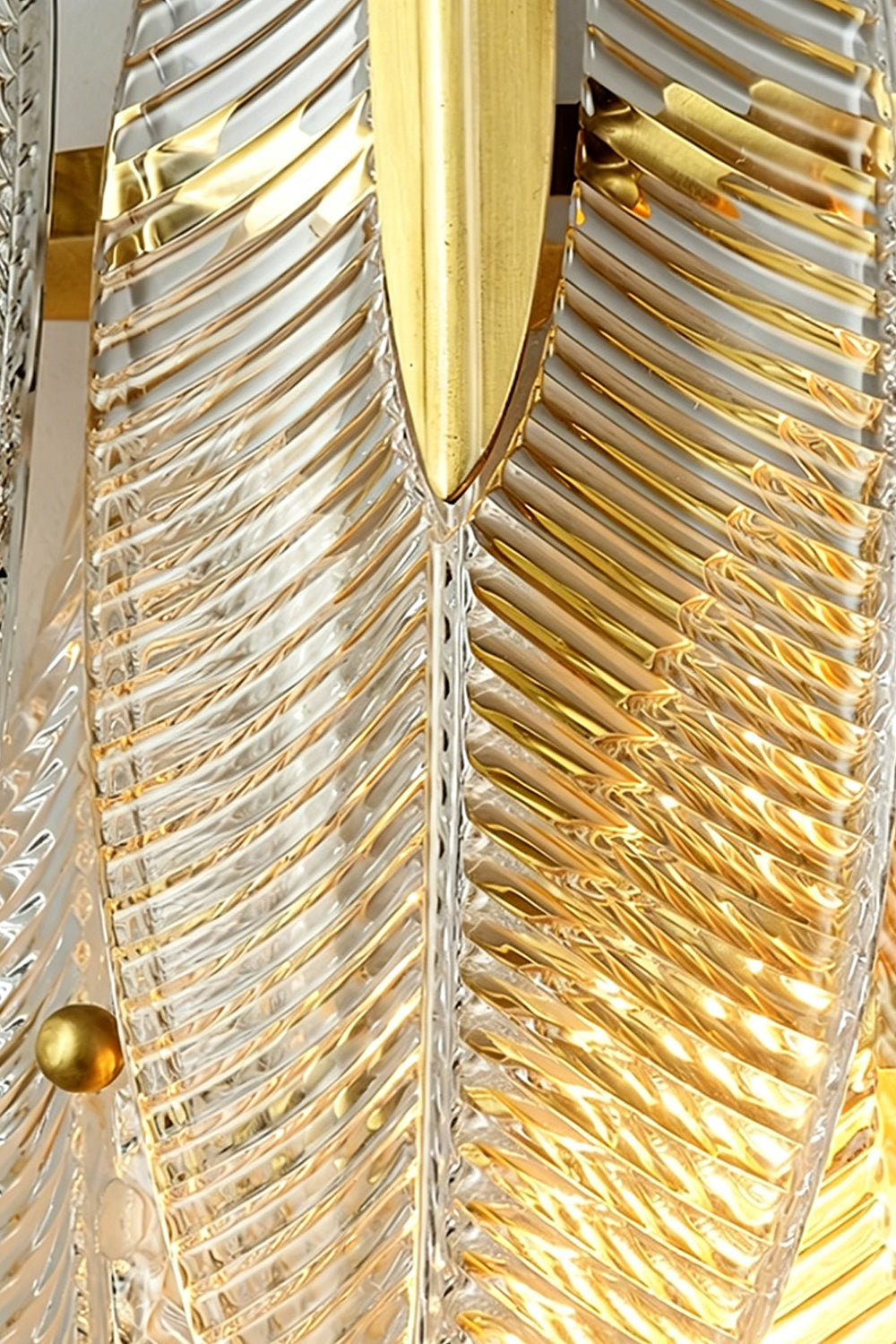 Elowen Cascading Glass Wall Lamp | Glass, Metal | Detailed close-up showing overlapping textured glass panels secured tightly on a gold frame with polished gold cylindrical nuts | Detail shot | Samu Lamp