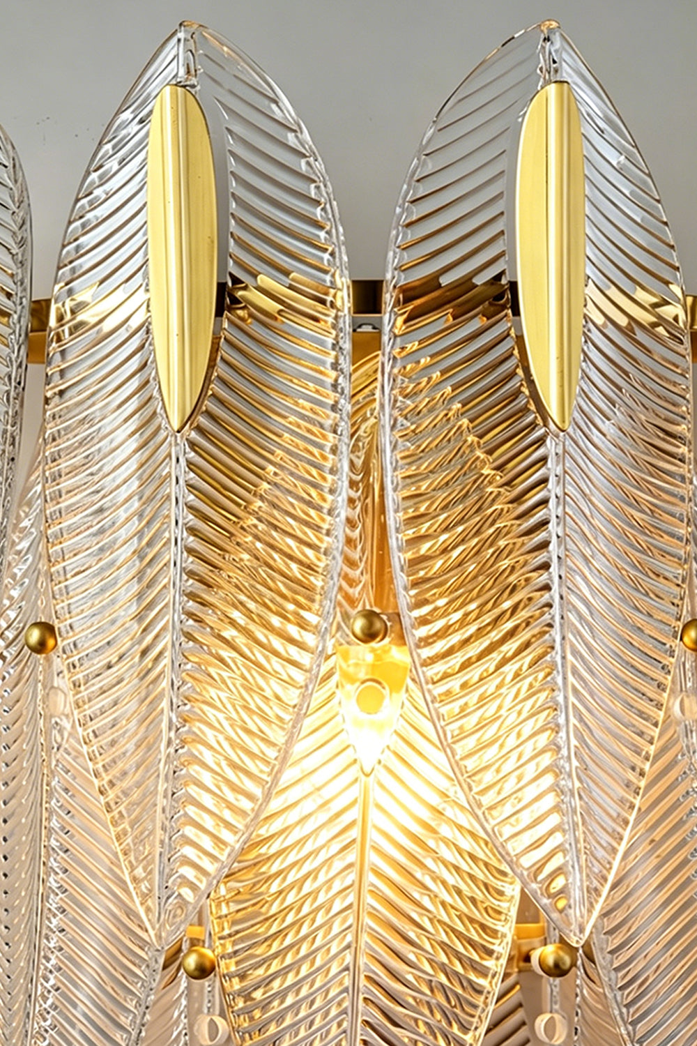 Elowen Cascading Glass Wall Lamp | Glass, Metal | Macro close-up view highlighting the glowing ribbed texture and feathery edges of the lit clear glass panels | Detail shot | Samu Lamp